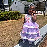 child, girl, dress, purple, pink, outdoor, sunny, smiling, concrete, grass, hedge, blue_sky, shoes, bracelet, hair_bow, cute, happy, portrait, daylight, standing