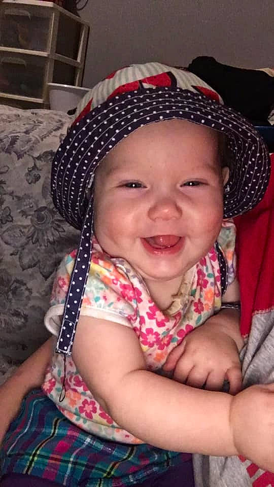 Heather is registered to the contest to win money with this photo: baby, bonnet, cheek, child, fashion_accessory, hair_accessory, hat, head, headgear, joy, person, skin, smile, toddler