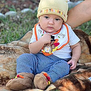 Brady joined the competition — help win amazing prizes! baby, baseballcap, bodypart, cap, clothing, costume, face, finger, grass, hand, hat, head, jeans, pants, person, photography, plant, portrait, rock, sitting