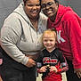 child, adult, smile, group, indoor, people, sportswear, trophy, glasses, hoodie, happy, team, portrait, casual, red_clothing, black_clothing, light_skin, dark_skin, cheerful, posing