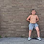Malachi joined the competition — help win amazing prizes! boy, child, shirtless, shorts, sneakers, brick_wall, sidewalk, outdoor, casual, serious_expression, sitting, three_children, summer, hair, face, legs, clothing, resting, group, youth