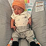 Rylan joined the competition — help win amazing prizes! baby, infant, hat, knit_hat, baby_bouncer, clothing, gray_pants, black_socks, expression, indoor, floor, carpet, toy_pattern, rainbow, monkey, sun, child, newborn, cute, relaxing