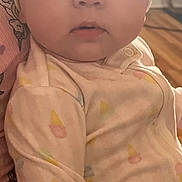 Olivia is registered to the contest to win money with this photo: baby, infant, headband, bow, onesie, pastel_colors, indoor, person_holding, curious_expression, wide_eyes, hand, soft_lighting, child, cute, portrait, clothing, skin, face, young_child, human