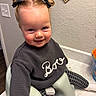 child, toddler, girl, baby, smiling, portrait, indoor, high_chair, bow, pigtails, blonde_hair, sweater, pants, seated, kitchen, bathroom, sink, cup, wall, happy