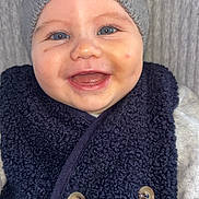 Raphaël participe au concours pour gagner de l'argent avec cette photo : baby, smile, blue_eyes, knit_hat, vest, button, face, cheek, skin, clothing, warm, happy, child, infant, portrait, cute, closeup, indoors, person, headwear