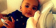 Ezaraye Evans joined the competition — help win amazing prizes! accessories, baby, blanket, bodypart, clothing, couch, cushion, electronics, face, finger, furniture, hand, head, homedecor, mobilephone, person, phone, photography, portrait, t_shirt