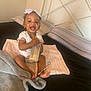 Ezaraye Evans is registered to the contest to win money with this photo: baby, beverage, bodypart, cup, cushion, cutlery, face, finger, furniture, hand, happy, head, homedecor, milk, person, photography, portrait, sitting, smile, spoon
