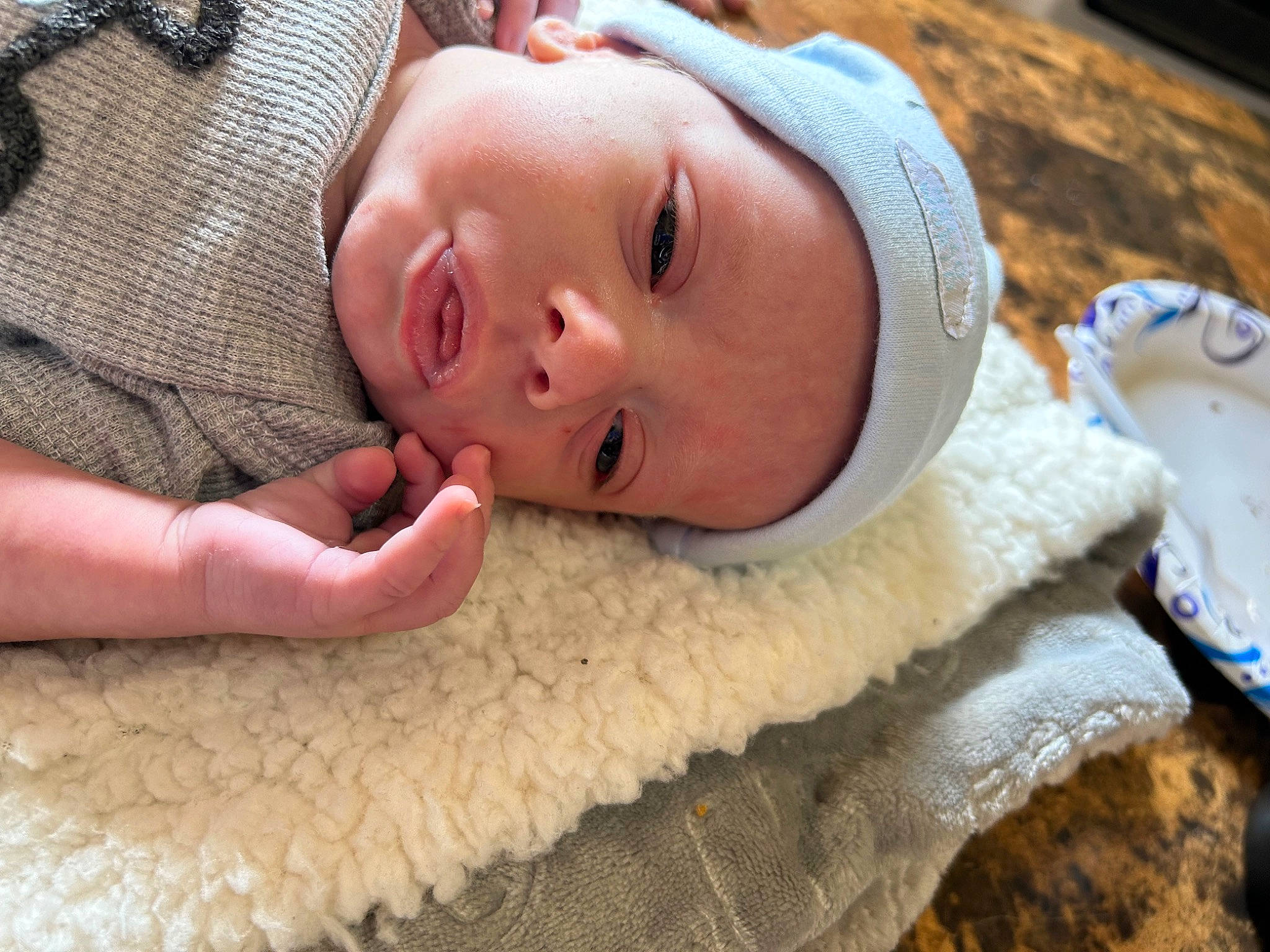 Ace is registered to the contest to win money with this photo: baby, baby_toddler_clothing, cheek, child, comfort, eyebrow, face, flooring, fun, grass, happy, hat, iris, linens, lip, nose, person, skin, textile, toddler