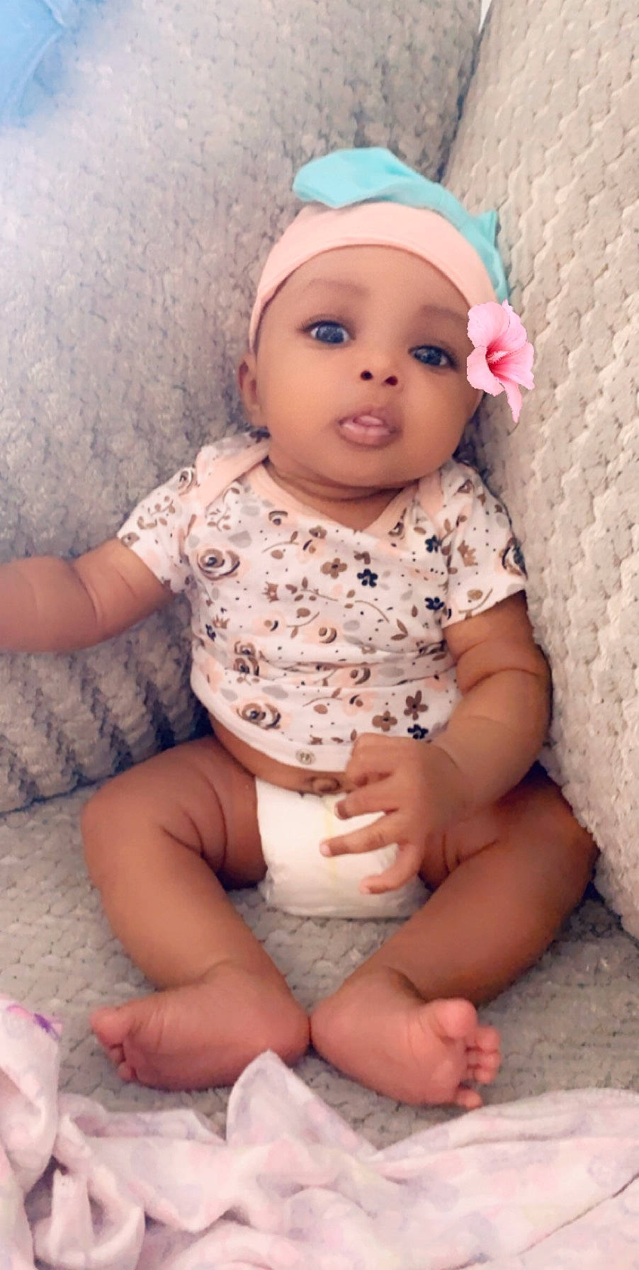 Lauryn is registered to the contest to win money with this photo: baby, baby_products, baby_toddler_clothing, cheek, child, hair_accessory, headgear, person, pink, skin, smile, toddler