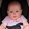 Thea is registered to the contest to win money with this photo: baby, child, infant, car_seat, blue_eyes, pink_shirt, denim, tongue_out, cute, chubby_cheeks, straps, graco, portrait, closeup, adorable, young, person, seatbelt, casual_clothing, indoor