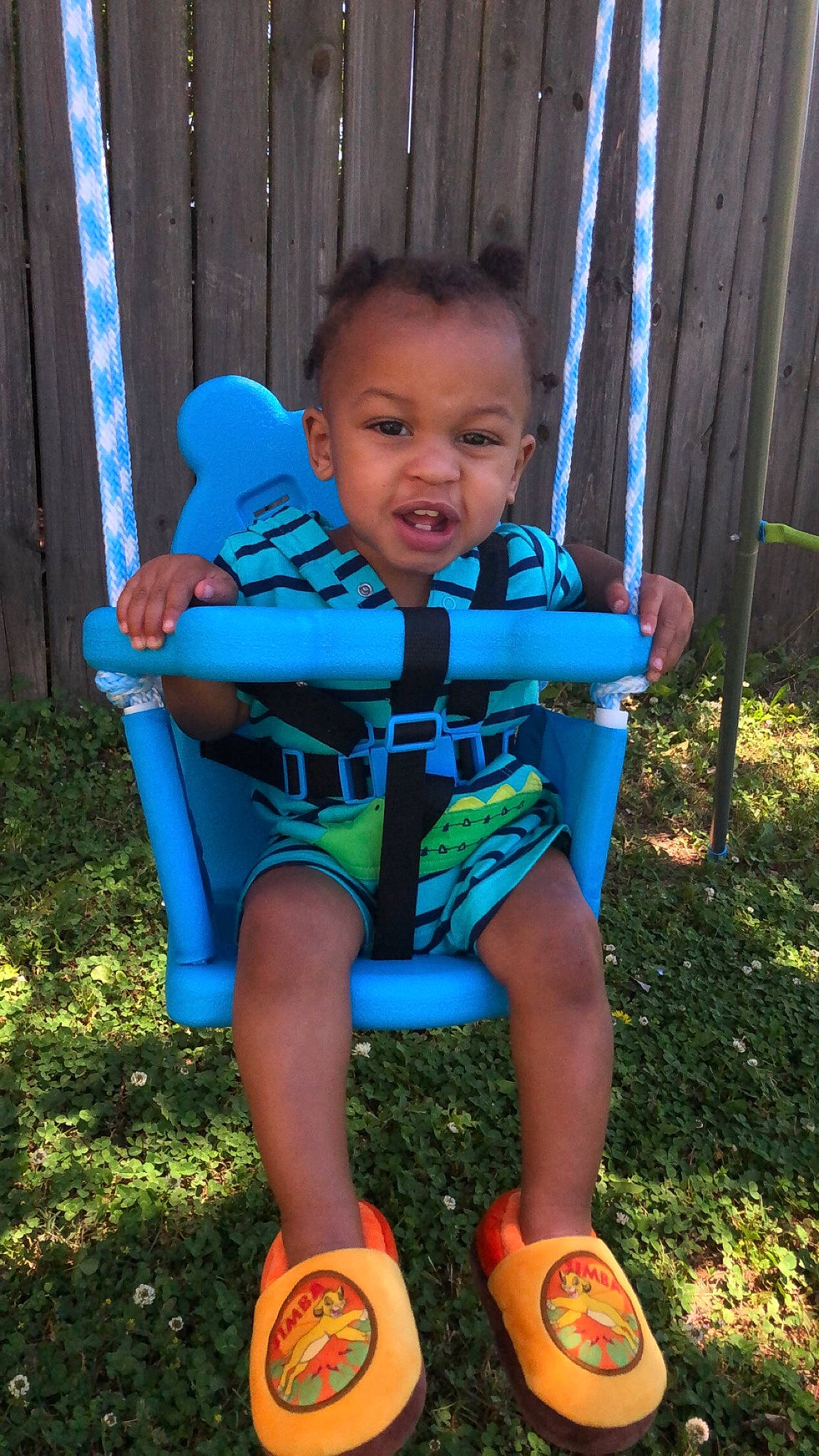 Teejay is registered to the contest to win money with this photo: baby_products, baby_toddler_clothing, blue, chair, child, electric_blue, fun, grass, happy, head, leisure, people_in_nature, person, plant, recreation, shoe, shorts, sitting, sneakers, t_shirt