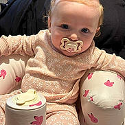 Isla-Ro joined the competition — help win amazing prizes! baby, pacifier, pajamas, hair_buns, pink, bunny_pattern, cushioned_seat, container, indoor, child, cute, infant, clothing, face, person, seat, toy, comfort, relaxed, small