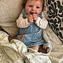 baby, blanket, blue_eyes, child, couch, cozy, curly_hair, cute, denim_dress, fabric, happy, indoor, person, plush_blanket, portrait, seated, smiling, socks, soft_texture, striped_shirt