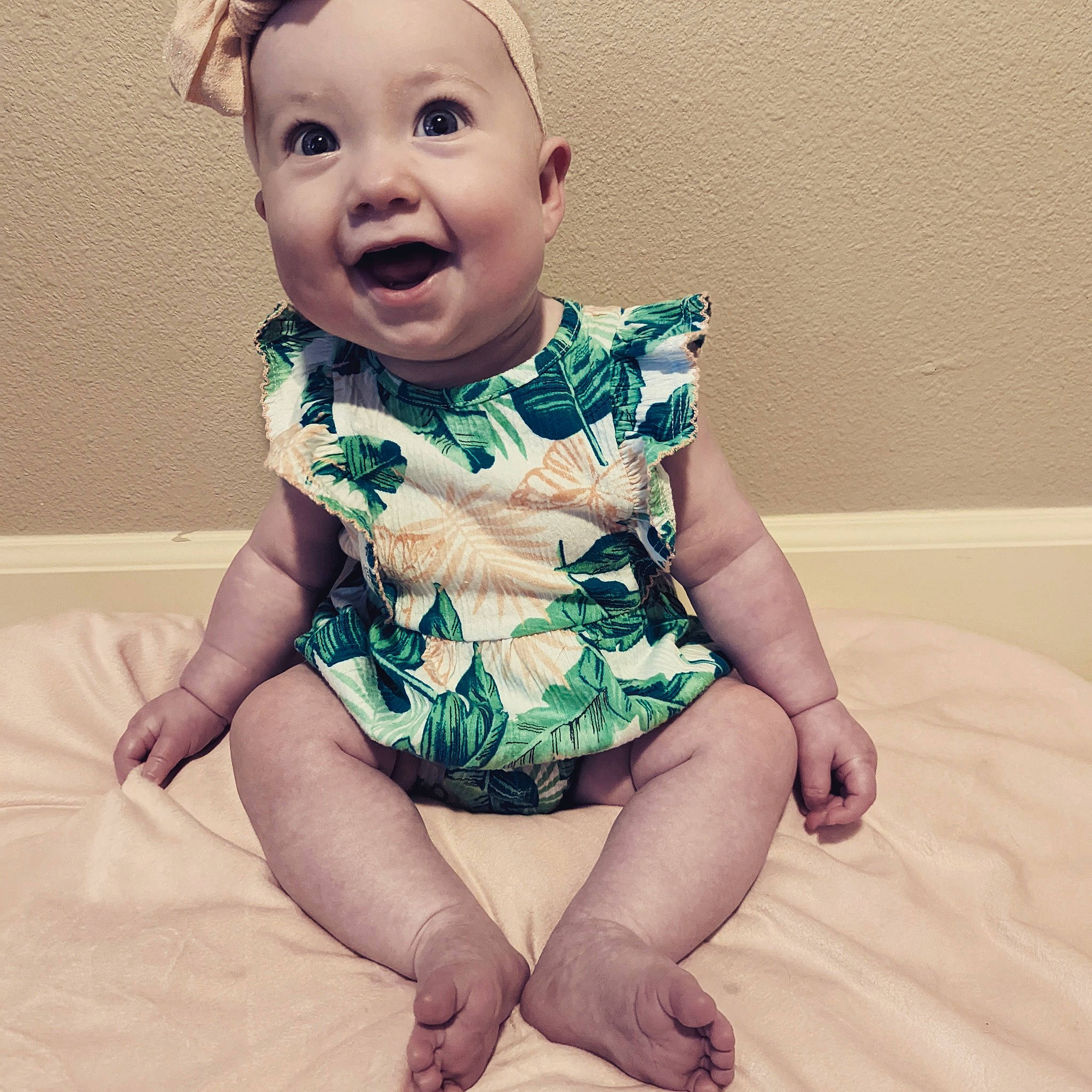 Calliope is registered to the contest to win money with this photo: arm, baby_toddler_clothing, cheek, chin, comfort, eye, face, facial_expression, hair, hairstyle, hand, happy, head, mouth, neck, organ, person, skin, sleeve, smile