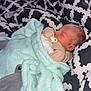 Blu is registered to the contest to win money with this photo: newborn, baby, sleeping, blanket, mittens, pacifier, bedspread, pattern, black_and_white, plush_toy, dolphin, cozy, infant, resting, soft, cute, indoors, portrait, child, comfort