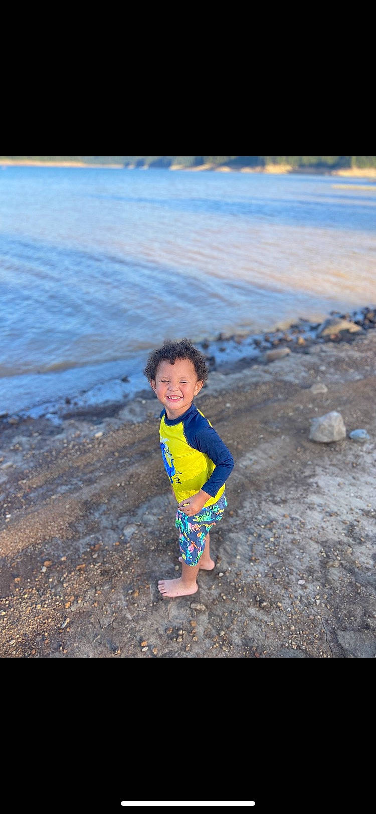 Cassius is registered to the contest to win money with this photo: azure, beach, cloud, coastal_and_oceanic_landforms, electric_blue, flash_photography, fun, happy, horizon, joy, landscape, leisure, natural_environment, people_in_nature, people_on_beach, person, sky, smile, summer, toddler