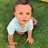 toddler, child, crawling, grass, outdoor, curious, face, blue_shirt, yellow_fence, green_lawn, baby, hands, feet, portrait, young_child, sunlight, expression, cheeks, skin, nature