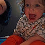 child, toddler, adult, curly_hair, smiling, open_mouth, patterned_clothing, teddy_bear_pattern, indoor, window, bed, orange_pants, person, face, happy, curly_hair_child, casual_clothing, home, portrait, light