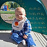 baby, child, infant, playground, outdoor, sitting, portrait, face, smiling, blue_clothing, checkered_shirt, bib, white_socks, sunlight, alphabet, play_structure, slide, grass, fence, daytime