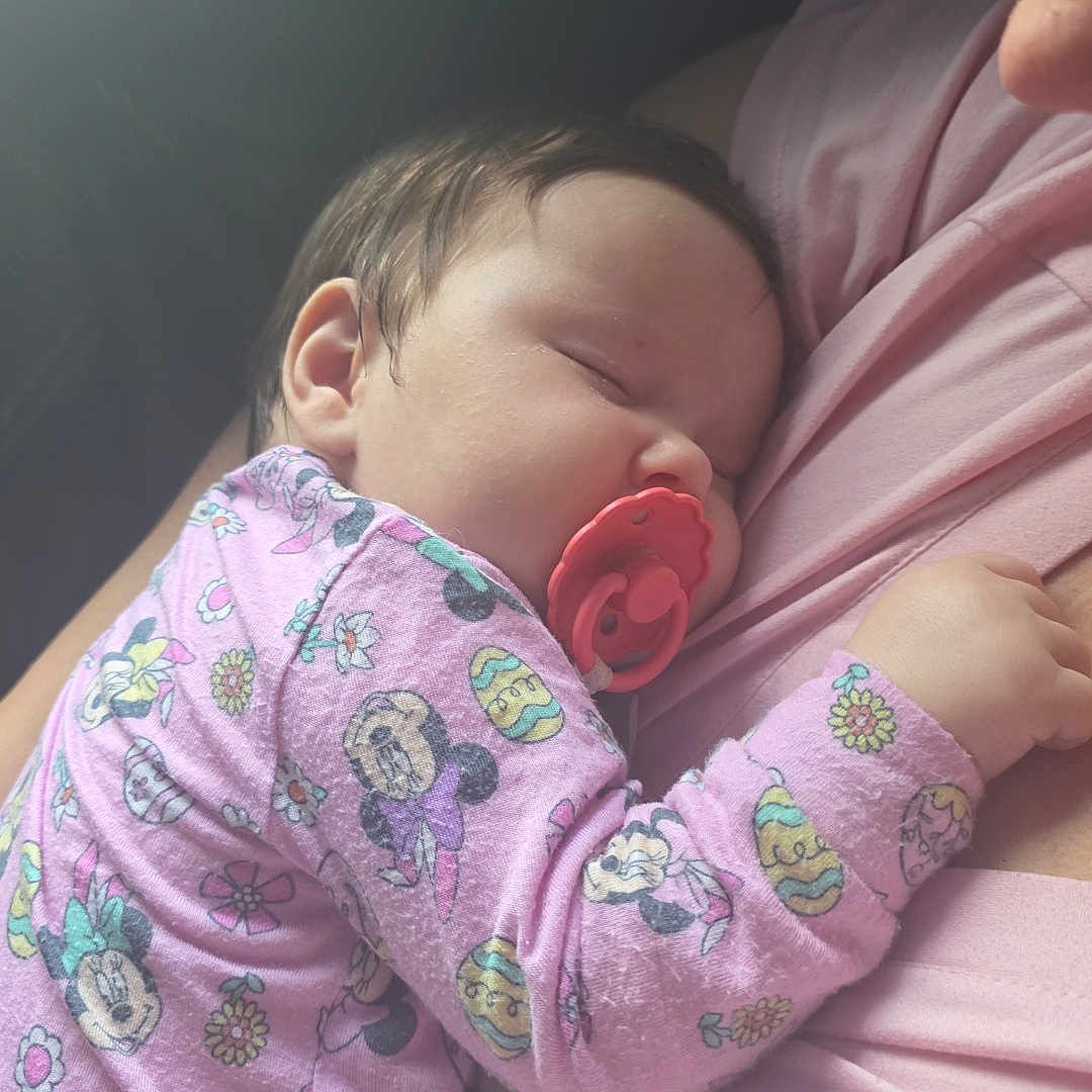 Aizzley is registered to the contest to win money with this photo: baby, sleeping, pacifier, pink_clothing, onesie, person, child, infant, cute, resting, toddler, mickey_mouse, soft_light, closeup, comfort, cuddling, nap, indoor, portrait, peaceful