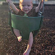 Kaysen is registered to the contest to win money with this photo: baby, swing, playground, child, smiling, outdoor, sunlight, chains, green_swing, barefoot, happy, play, infant, young_child, daylight, nature, park, person, fun, recreation