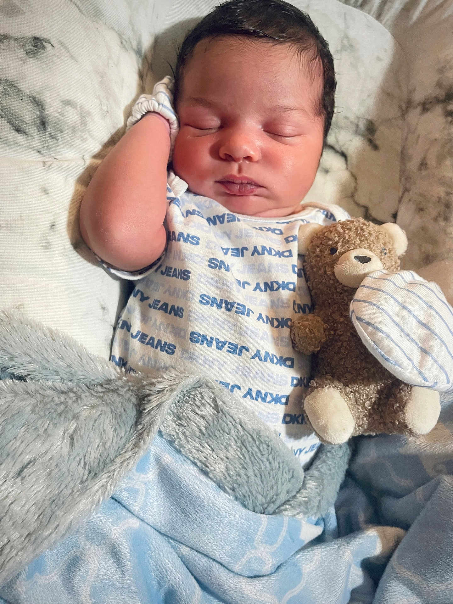 Kyrie is registered to the contest to win money with this photo: baby, sleeping, blanket, teddy_bear, onesie, child, soft_toy, cute, cozy, resting, infant, bed, fabric, comfort, peaceful, portrait, indoor, face, clothing, newborn