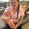 Roman joined the competition — help win amazing prizes! woman, baby, newborn, tattoos, braid, smile, couch, dog, indoor, family, holding, person, casual_clothing, home, portrait, happy, relaxed, light, skin, seated