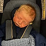 baby, sleeping, car_seat, blanket, child, infant, seatbelt, cozy, knitted, clothing, head, face, peaceful, young, portrait, indoors, safety, hair, resting, comfort