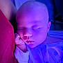 baby, sleeping, infant, purple_light, pajamas, hand, face, peaceful, cushion, red, closeup, indoors, soft_light, newborn, resting, portrait, child, cute, cozy, skin