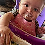 Danielle joined the competition — help win amazing prizes! baby, child, close_up, curious, cute, face, feeding_time, food, hand, happy, high_chair, indoor, infant, messy, person, pink_bib, purple, rainbow_pattern, smile, young_child