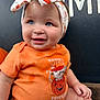 autumn, baby, background, blue_eyes, child, closeup, clothing, cute, face, fall, hand, headband, holiday, orange_shirt, person, portrait, pumpkin, seasonal, sitting, smiling