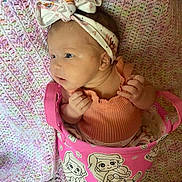 Danielle joined the competition — help win amazing prizes! baby, bow, bucket, cartoon, child, clothing, crocheted_blanket, curious, cute, face, headband, indoors, infant, mermaid, pastel_colors, pink, portrait, sitting, small_hands, soft_texture
