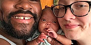 Love is registered to the contest to win money with this photo: family, baby, man, woman, glasses, smile, indoor, portrait, skin, hand, face, people, closeup, parent, child, love, together, happy, casual, holding