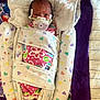 newborn, baby, swaddle, pacifier, medical_tube, blanket, heart_pattern, infant, bed, hospital, person, cute, wrapped, closeup, lying_down, small, face, head, healthcare, resting