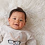 Maximus is registered to the contest to win money with this photo: baby, child, smiling, sweater, bunny, glasses, cute, portrait, infant, lying_down, white_background, fluffy_rug, soft_texture, warm_clothing, young_child, indoors, happy, face, cozy, comfortable