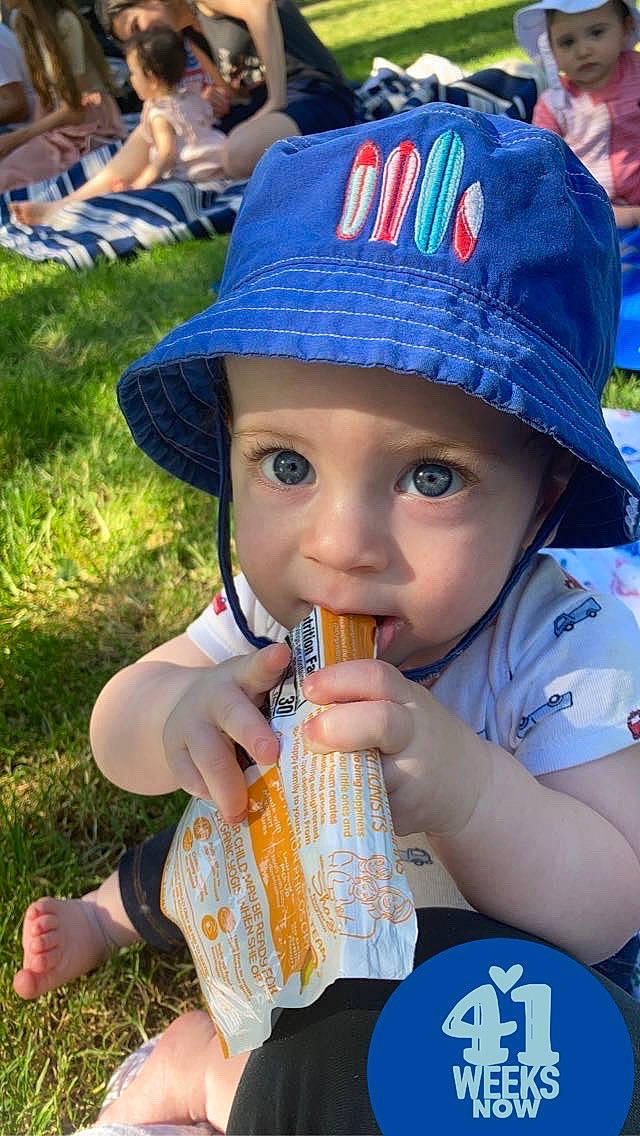 Sly is registered to the contest to win money with this photo: baby, baby_toddler_clothing, baseball_cap, blue, cap, child, cool, electric_blue, fashion_accessory, fun, grass, happy, hat, headgear, headwear, leisure, person, play, recreation, sun_hat