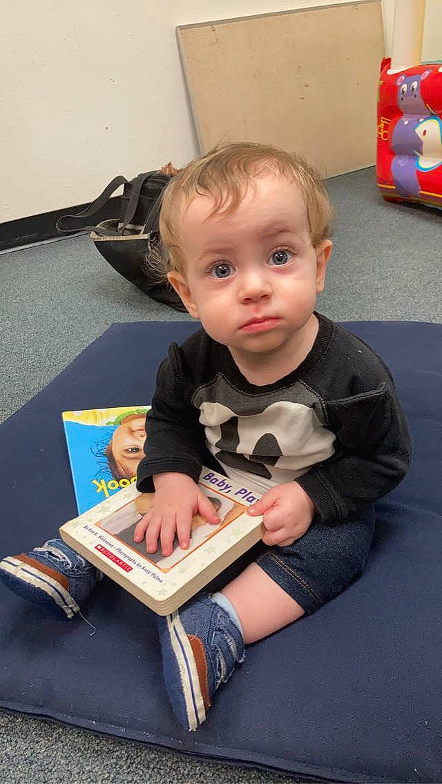 Sly joined the competition — help win amazing prizes! baby, baby_products, baby_toddler_clothing, book, carpet, cheek, child, comfort, flooring, fun, lap, person, play, product, publication, reading, room, sitting, toddler, vacation