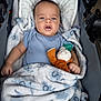 Koah joined the competition — help win amazing prizes! baby, baby_boy, blanket, blue_onesie, child, clothing, comfort, cute, expression, face, hand, indoor, infant, pacifier, plush_toy, portrait, resting, sleeping_bag, soft_texture, stroller