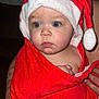 baby, child, face, blue_eyes, red_towel, santa_hat, wrapped, cute, portrait, infant, skin, hand, tattoo, expression, indoor, person, closeup, holiday, christmas, soft