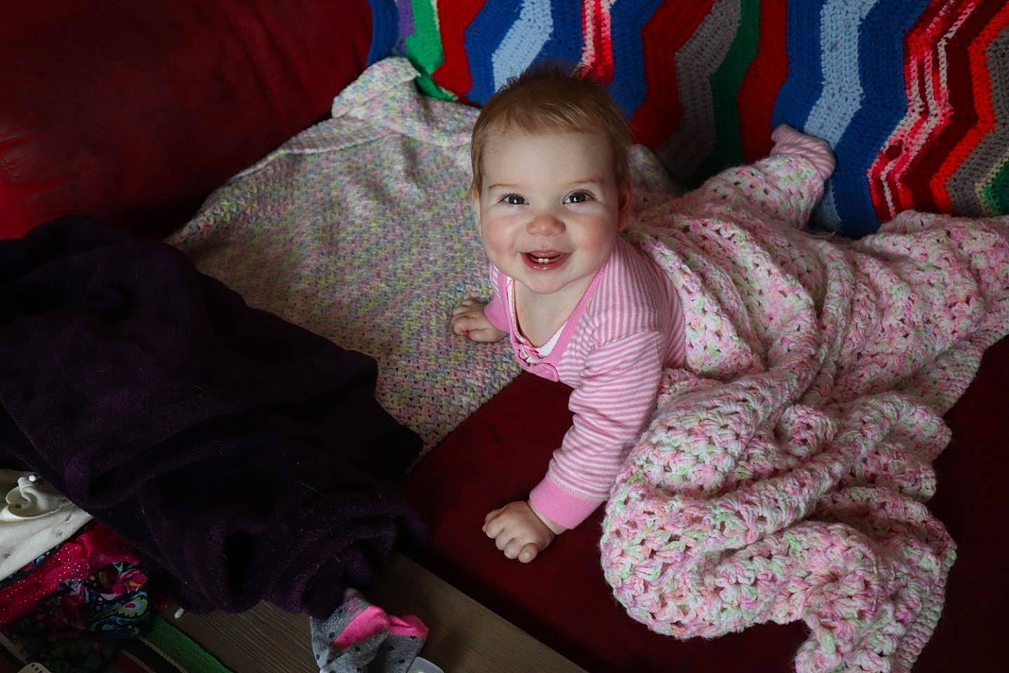 Marilyn is registered to the contest to win money with this photo: baby, cheek, child, eye, family, furniture, joy, people, person, pink, play, room, sitting, skin, smile, textile, toddler