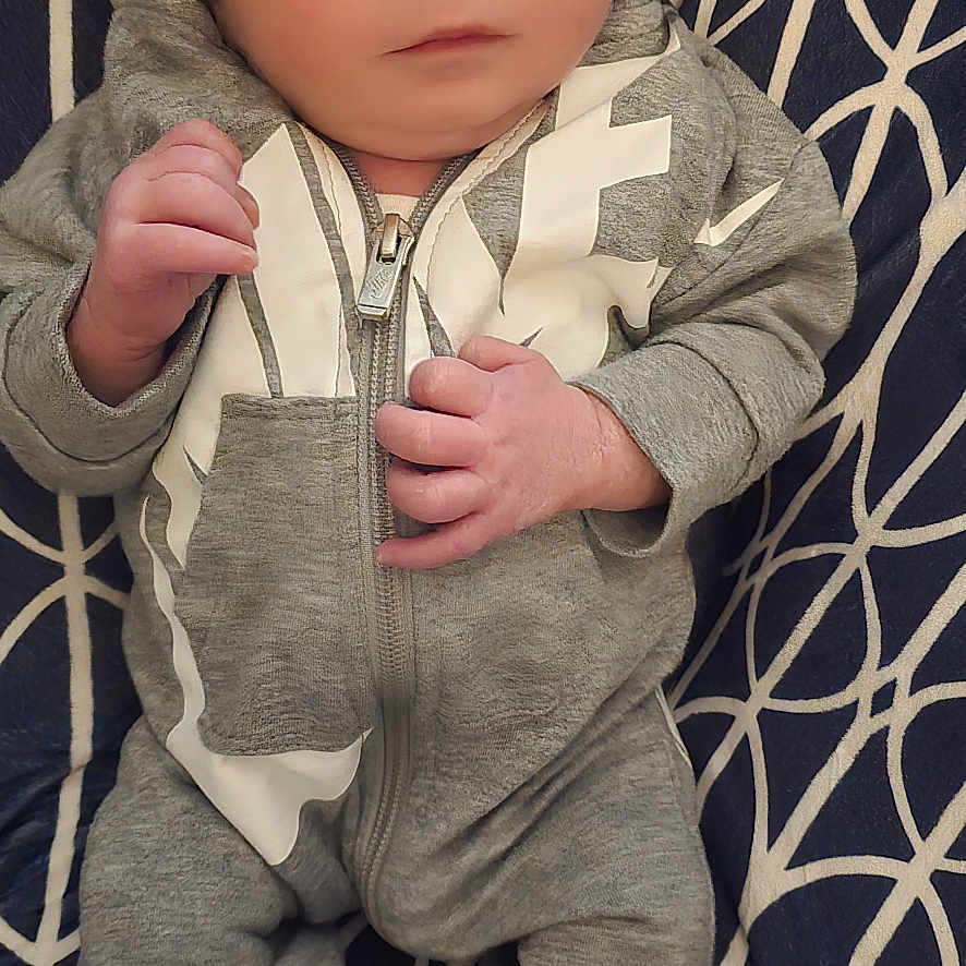 Brysin joined the competition — help win amazing prizes! baby, child, closeup, cozy, curious_expression, cushion, face, feet, gray_clothing, hands, indoor, infant, lying_down, newborn, onesie, patterned_background, portrait, socks, soft_lighting, warning_label