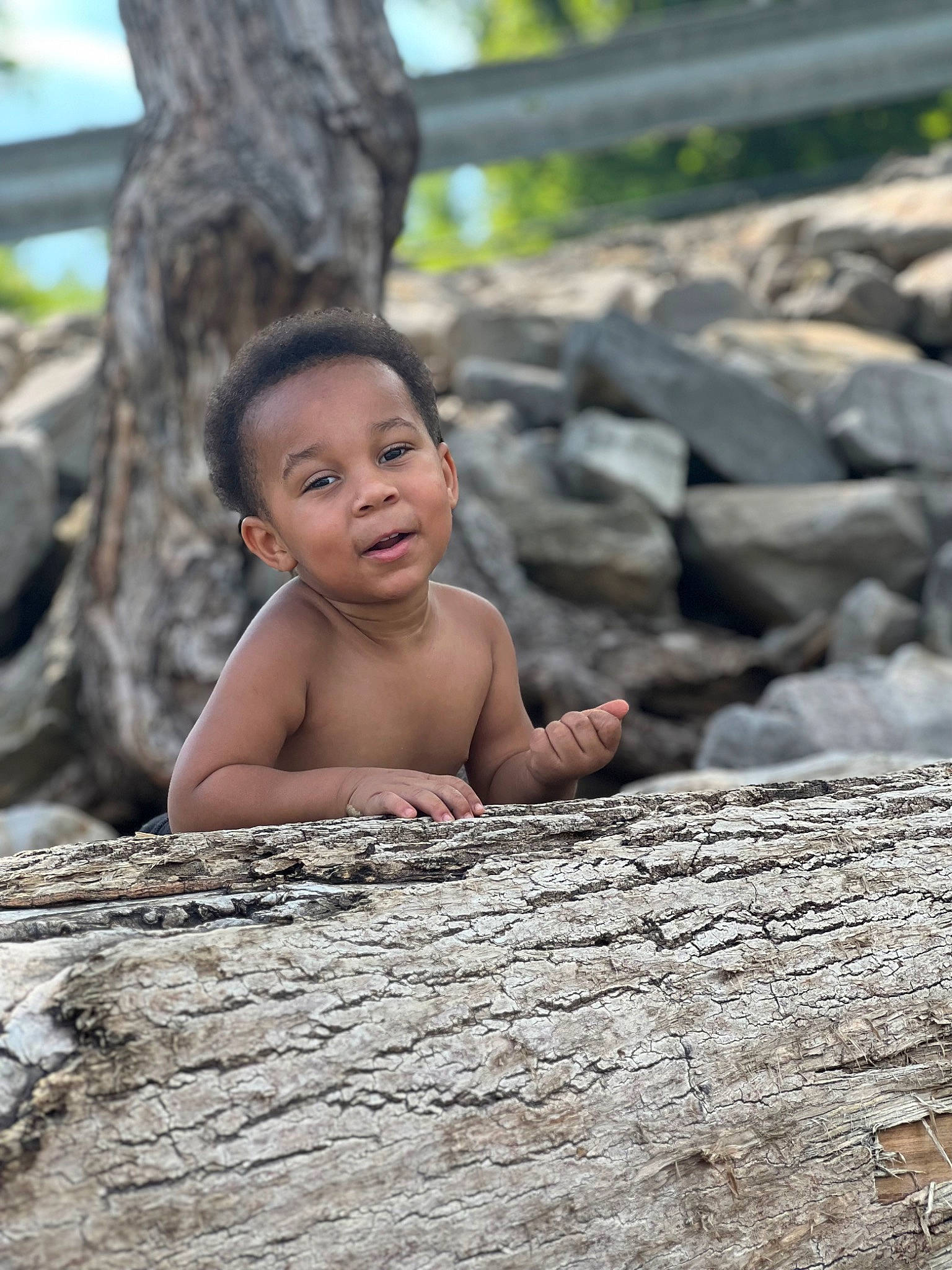Lorenzo is registered to the contest to win money with this photo: baby, child, chin, flash_photography, fun, grass, happy, head, landscape, leisure, mammal, people_in_nature, person, plant, sitting, skin, smile, toddler, tree, trunk