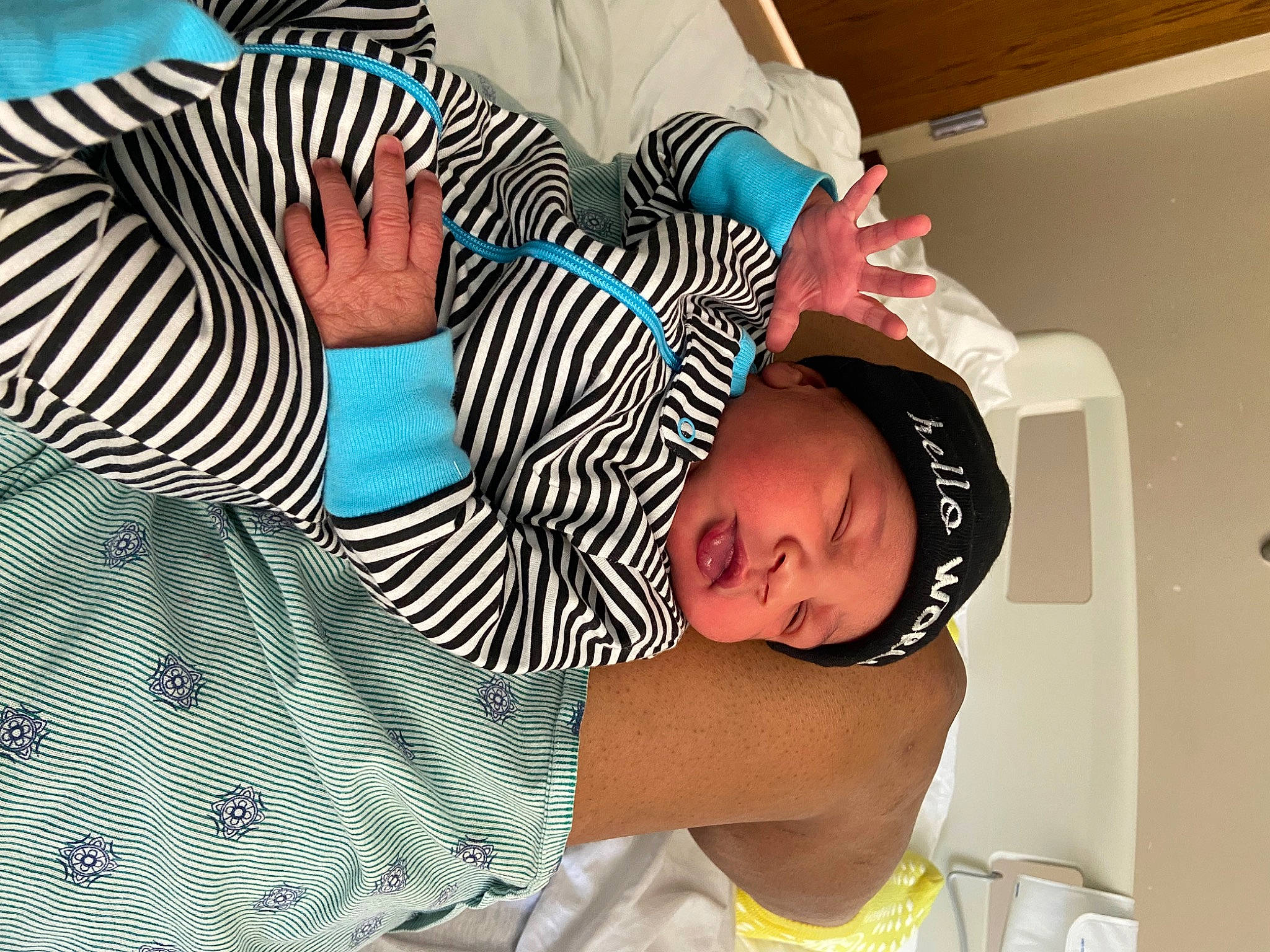 Johnathan is registered to the contest to win money with this photo: baby, baby_toddler_clothing, child, comfort, elbow, fun, hairstyle, happy, hat, headwear, human_body, leisure, pattern, person, sitting, sleeve, t_shirt, textile, toddler, white