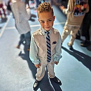 Keyon Carter joined the competition — help win amazing prizes! child, boy, suit, tie, vest, dress_shoes, curly_hair, indoor, event, crowd, portrait, formal_wear, smile, young_child, shallow_depth_of_field, spotlight, floor, shadow, people, blurred_background