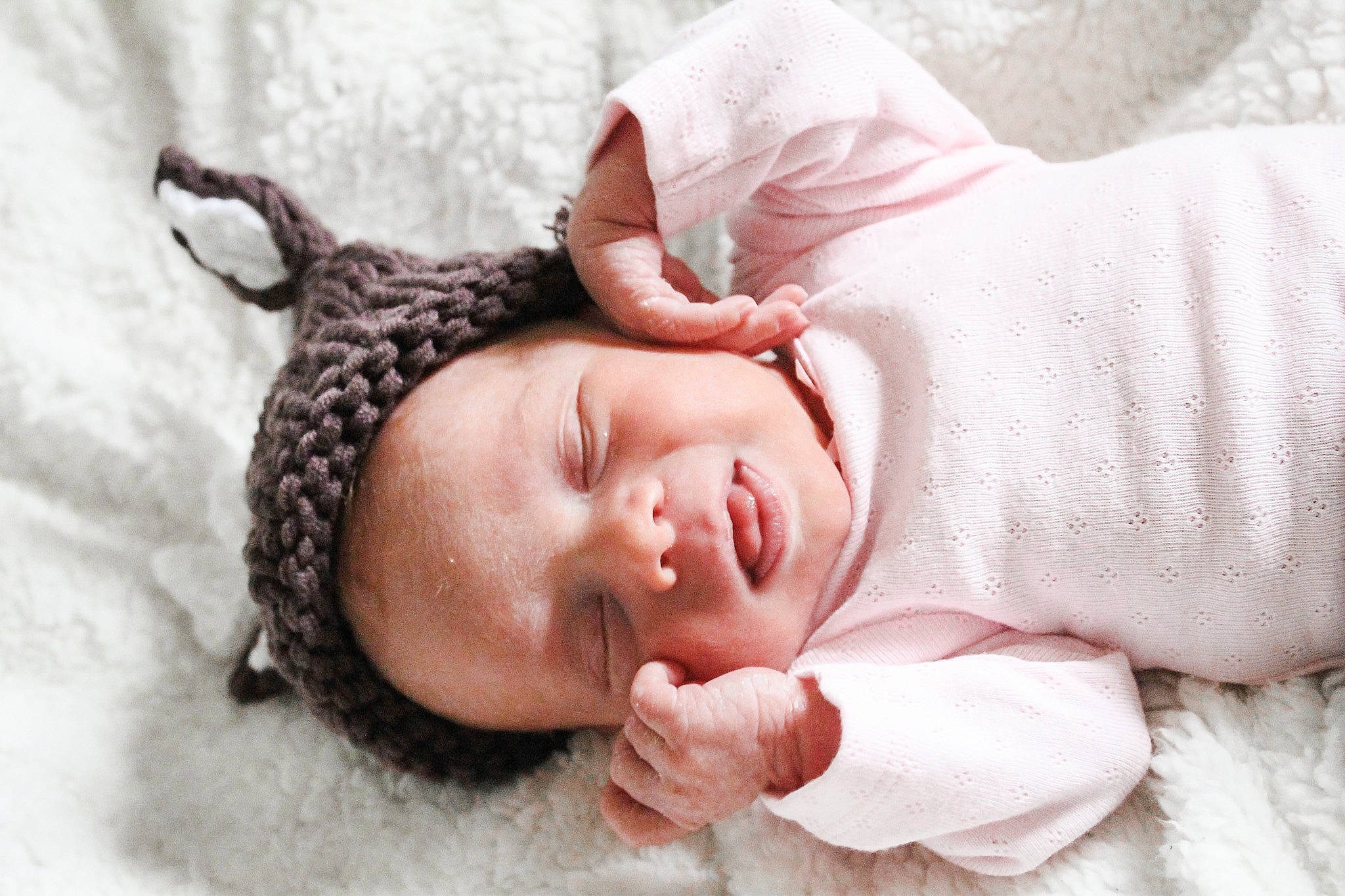 Jordyn is registered to the contest to win money with this photo: arm, baby, baby_sleeping, baby_toddler_clothing, cap, comfort, ear, eyelash, happy, head, headgear, human_body, knit_cap, linens, lip, nose, person, pink, skin, textile