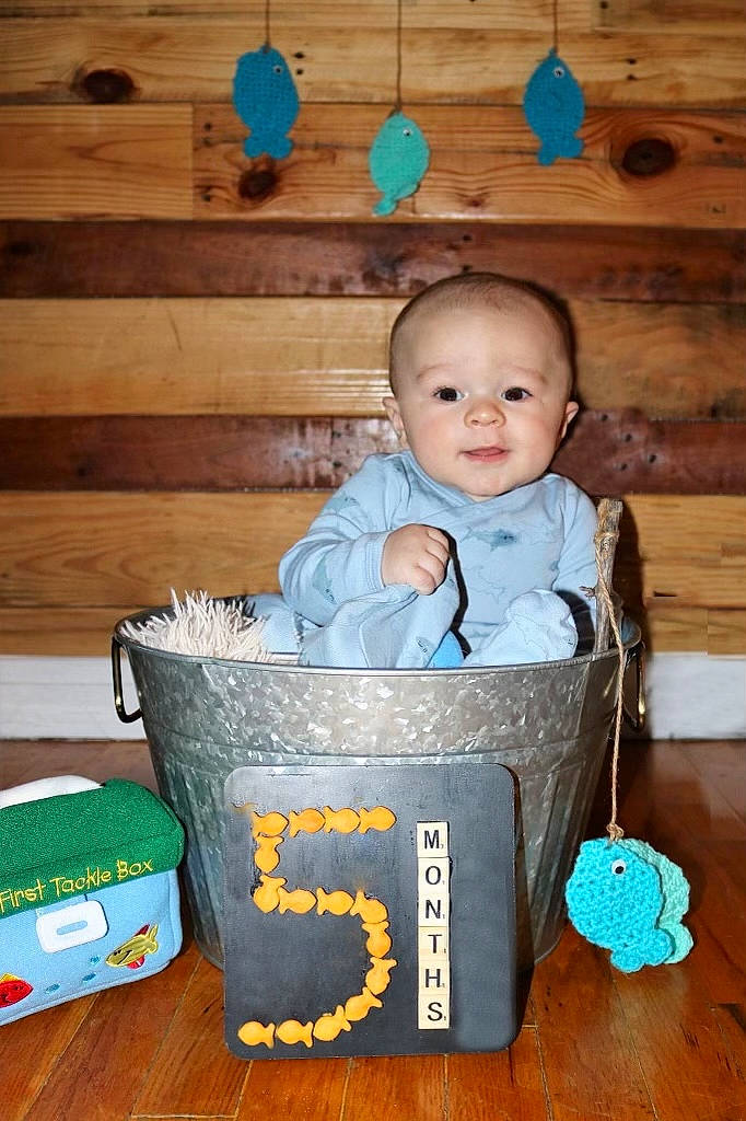 Brandon is registered to the contest to win money with this photo: baby, baby_products, baby_safety, baby_toddler_clothing, basket, blue, cheek, child, flooring, fun, green, happy, hardwood, laundry_basket, person, portrait_photography, room, sitting, smile, toddler