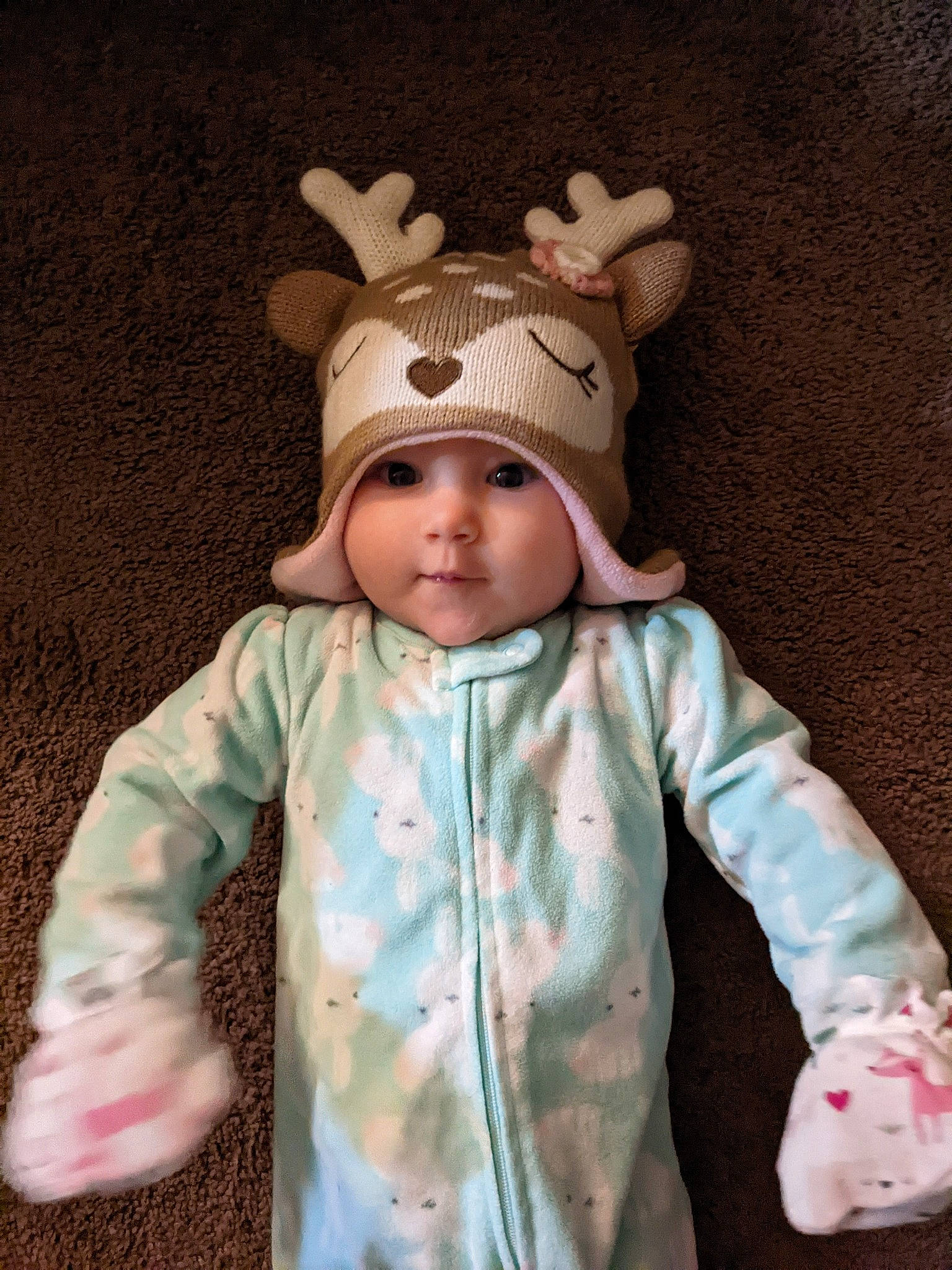 Nyx is registered to the contest to win money with this photo: baby, baby_toddler_clothing, cap, cheek, child, eye, eyelash, face, head, headwear, jacket, knit_cap, outerwear, pattern, person, pink, skin, sleeve, textile, toddler