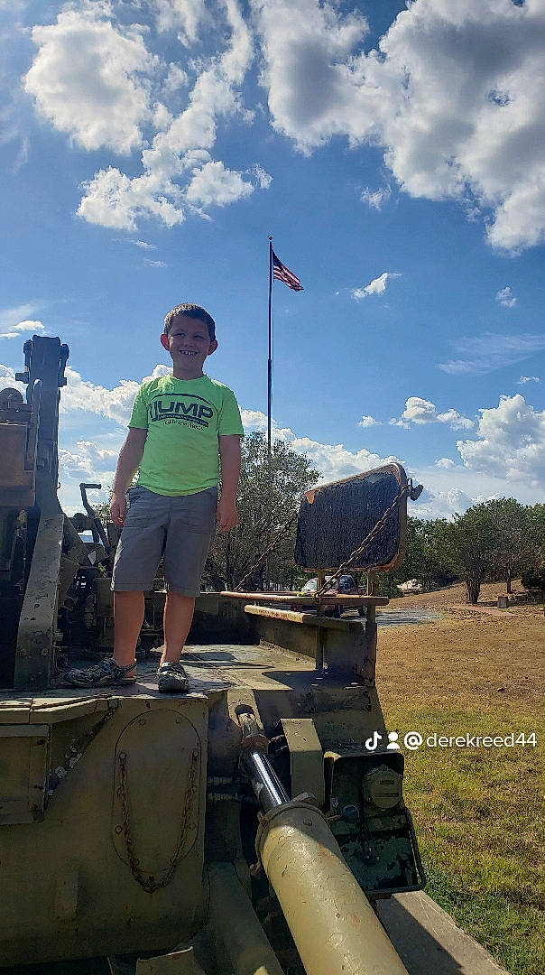 Damian joined the competition — help win amazing prizes! asphalt, automotive_tire, cloud, cumulus, flag, fun, grass, grassland, hat, joy, landscape, leisure, person, personal_protective_equipment, plant, recreation, shorts, sky, soil, t_shirt