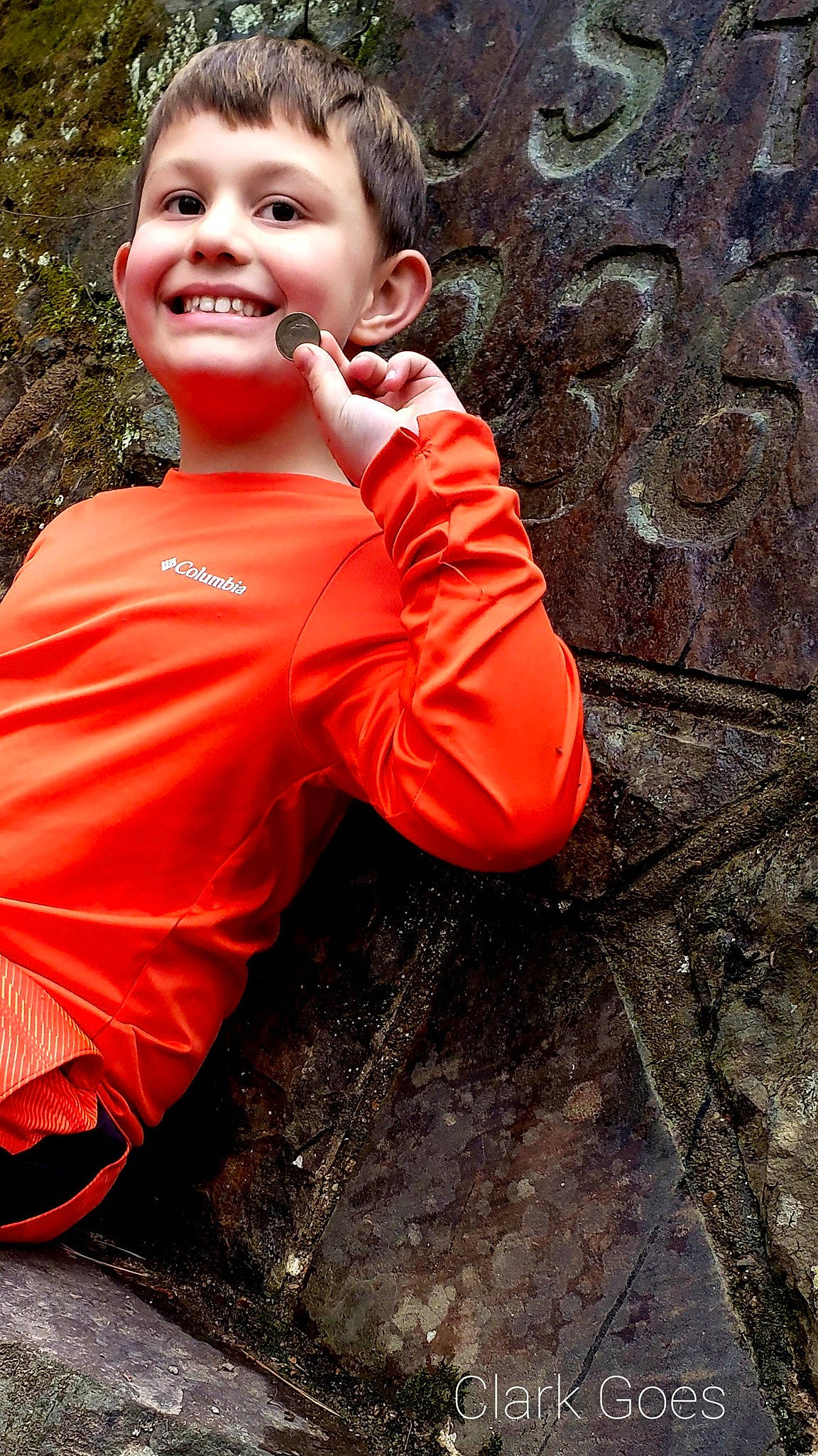 Damian joined the competition — help win amazing prizes! child, chin, eye, flash_photography, fun, grass, happy, joy, leisure, orange, people_in_nature, person, plant, portrait_photography, sitting, smile, soil, t_shirt, temple, toddler