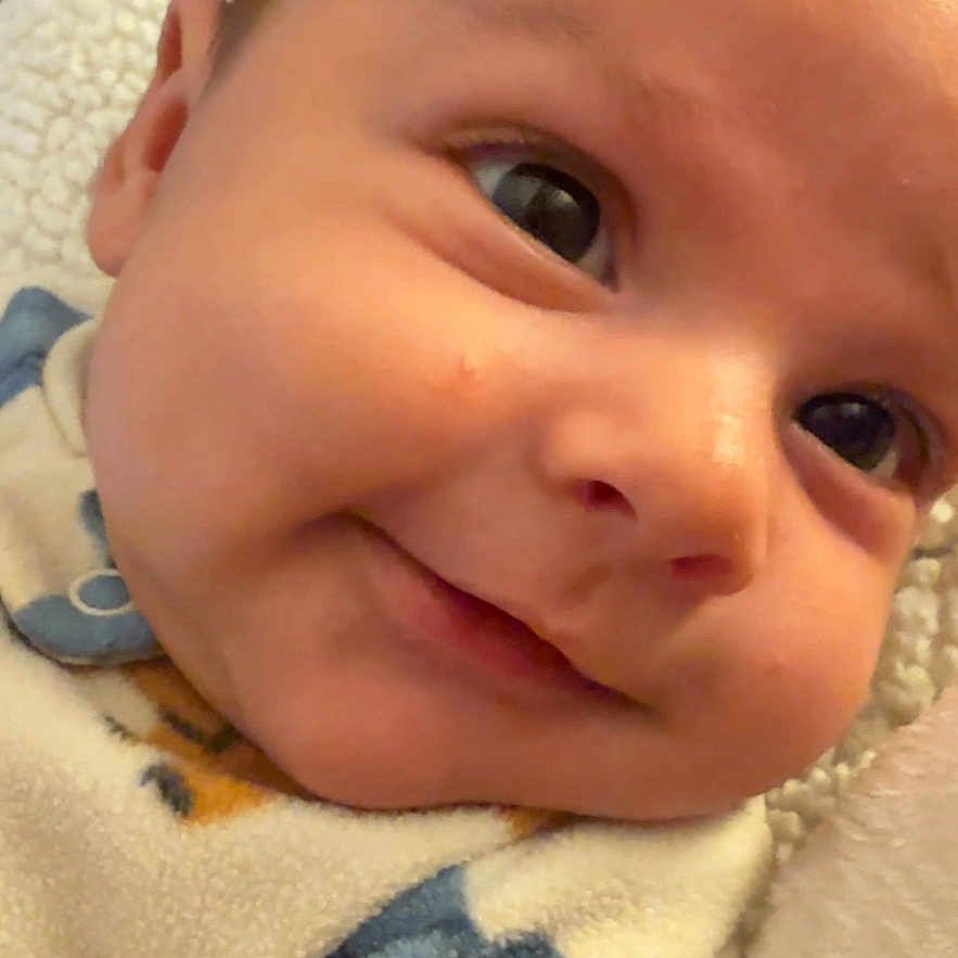 Zahmir joined the competition — help win amazing prizes! adorable, baby, bedding, blanket, cheek, close_up, clothing, cozy, expression, eyelashes, eyes, face, head, indoors, infant, newborn, nose, portrait, skin, smile